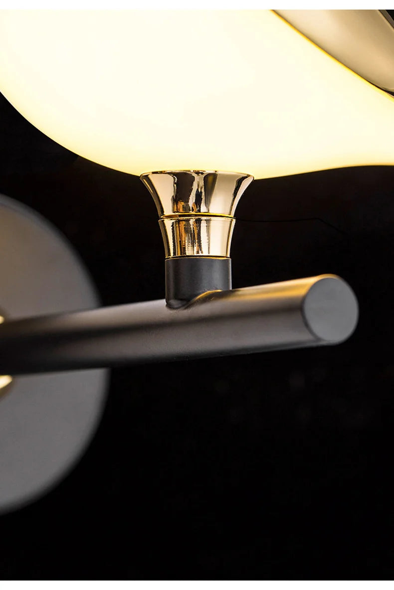 Luminous Lumens: The Modern Bird Sconce with Golden Glow