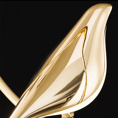 Luminous Lumens: The Modern Bird Sconce with Golden Glow