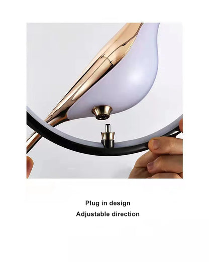 Luminous Lumens: The Modern Bird Sconce with Golden Glow